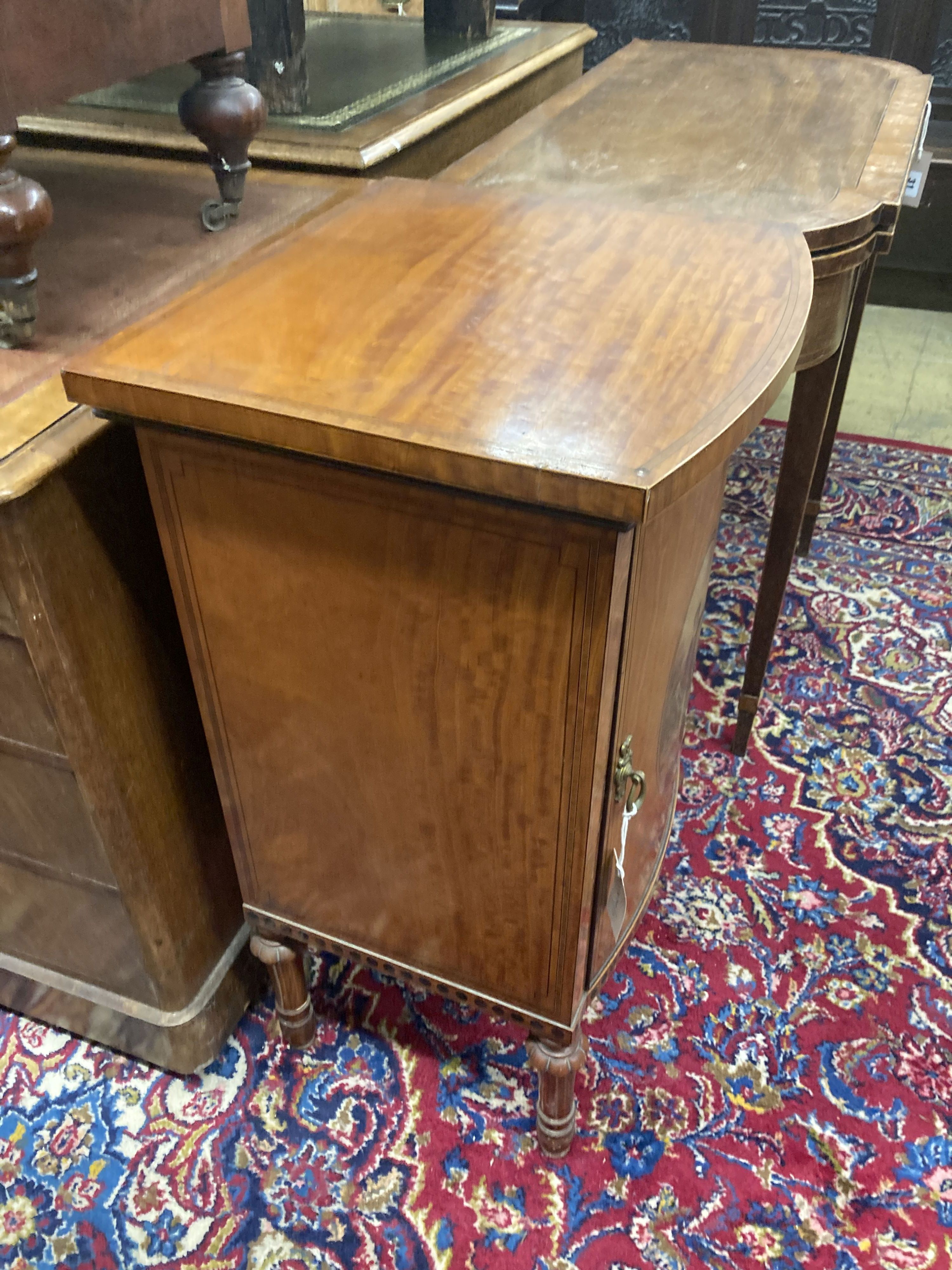 An Edwardian Sheraton revival painted satinwood bow front bedside cabinet, width 44cm, depth 39cm, height 78cm